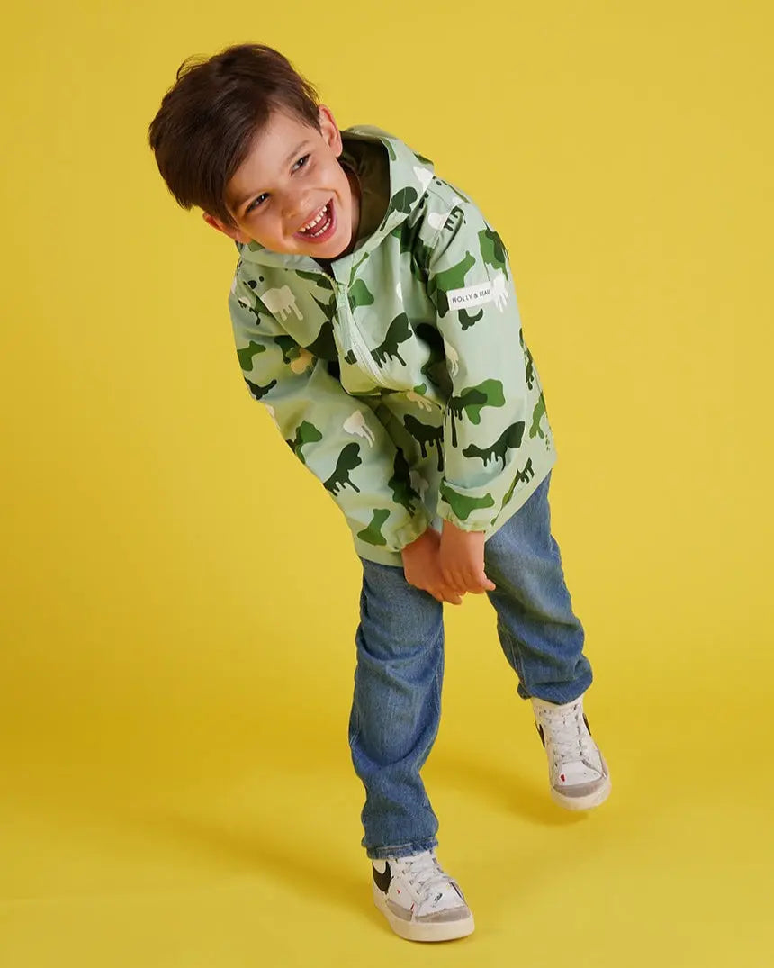 Holly and Beau laughing boy in green colour changing camouflage raincoat