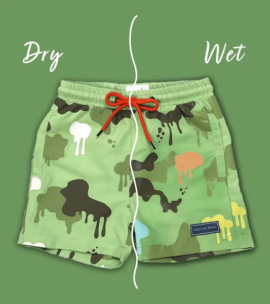 Holly and Beau Colour changing Green swim shorts with Camouflage print and Orange drawstring on a green background showing the dry and sides