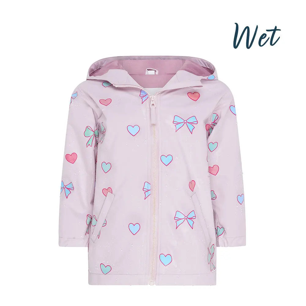 Wet front view of the pink bows and hearts colour changing raincoat by Holly and Beau