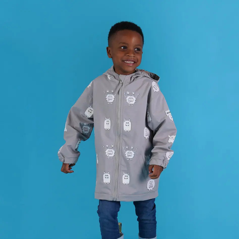 Holly and Beau toddler boy smiling wearing monster colour changing raincoat 