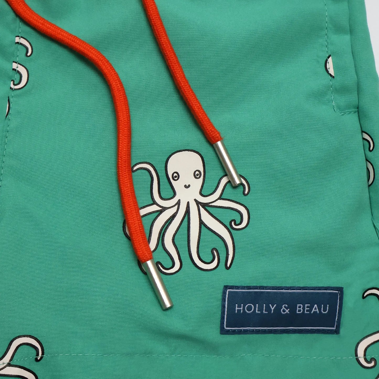 Holly and Beau colour changing swim shorts front detail of the drawstring and logo