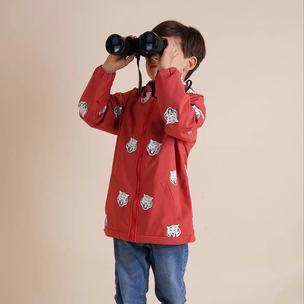 Toddler boy wearing his red tiger colour changing raincoat