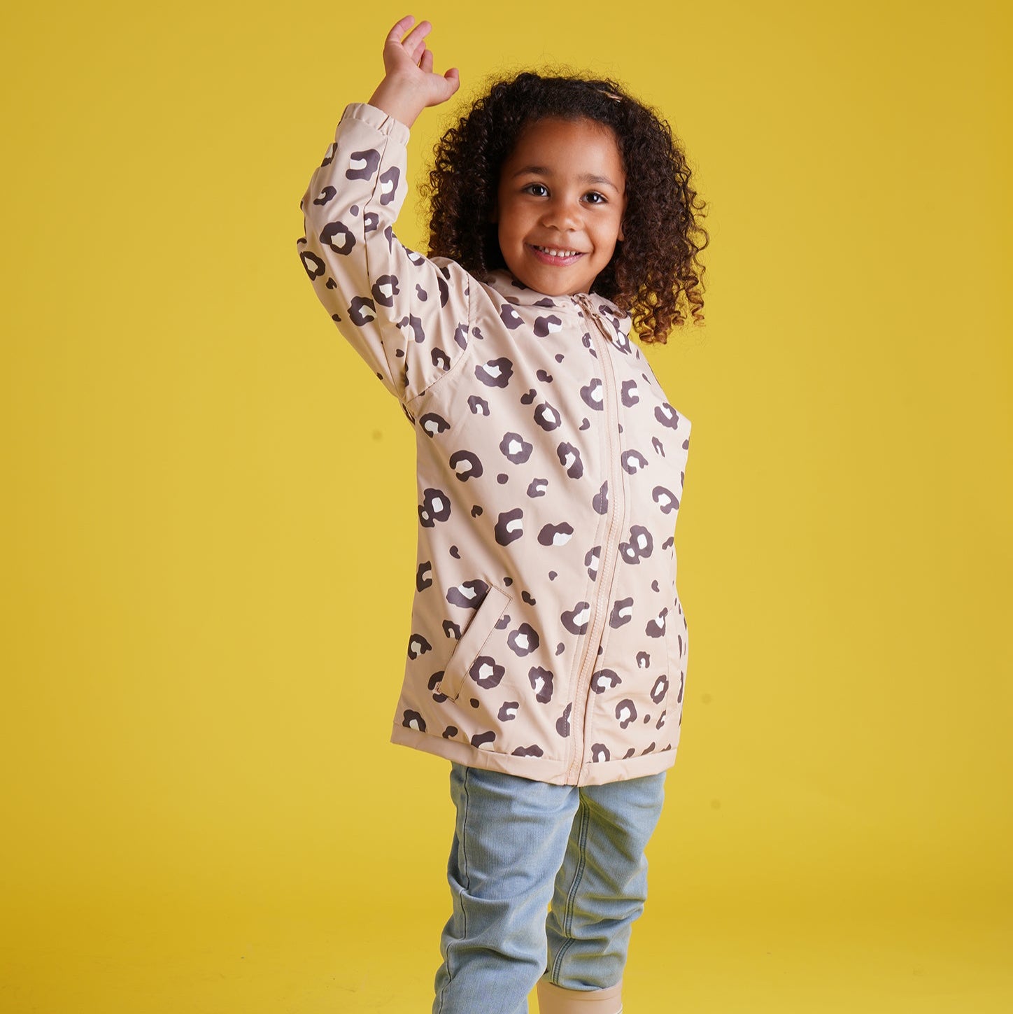 Holly and Beau smiling girl wearing leopard print colour changing raincoat