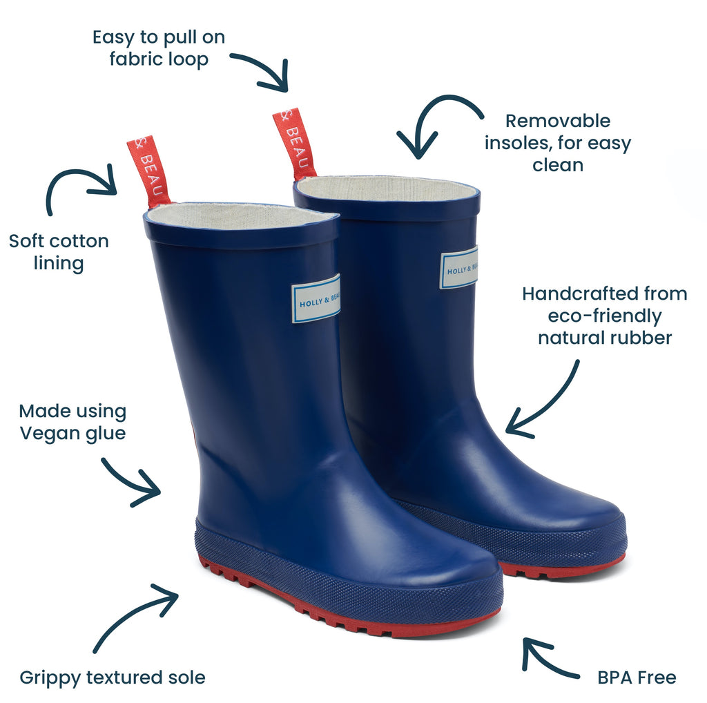 Blue and red rubber boys wellies by rainwear brand Holly and Beau. Made from natural rubber, ideal for rainy days and muddy puddles. A great gift for a little boy and a little girl