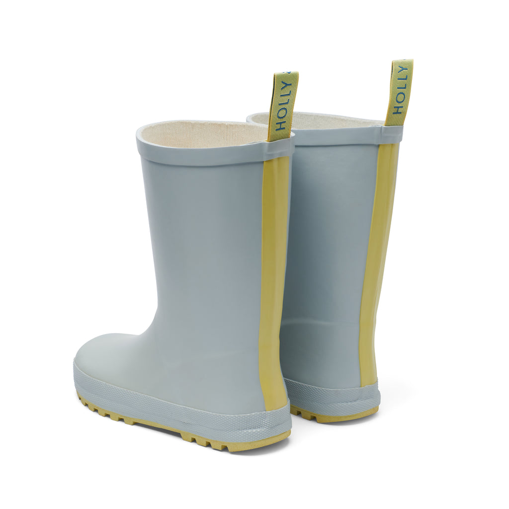 Light blue and yellow girls rubber rain boots by rainwear brand Holly and Beau. Made from natural rubber, ideal for rainy days and muddy puddles. A great gift for a little boy and a little girl